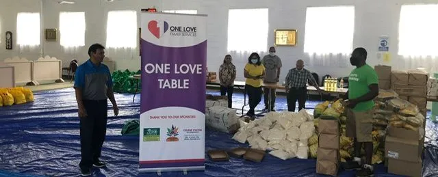 Volunteers sorting and packing hampers in a community hall