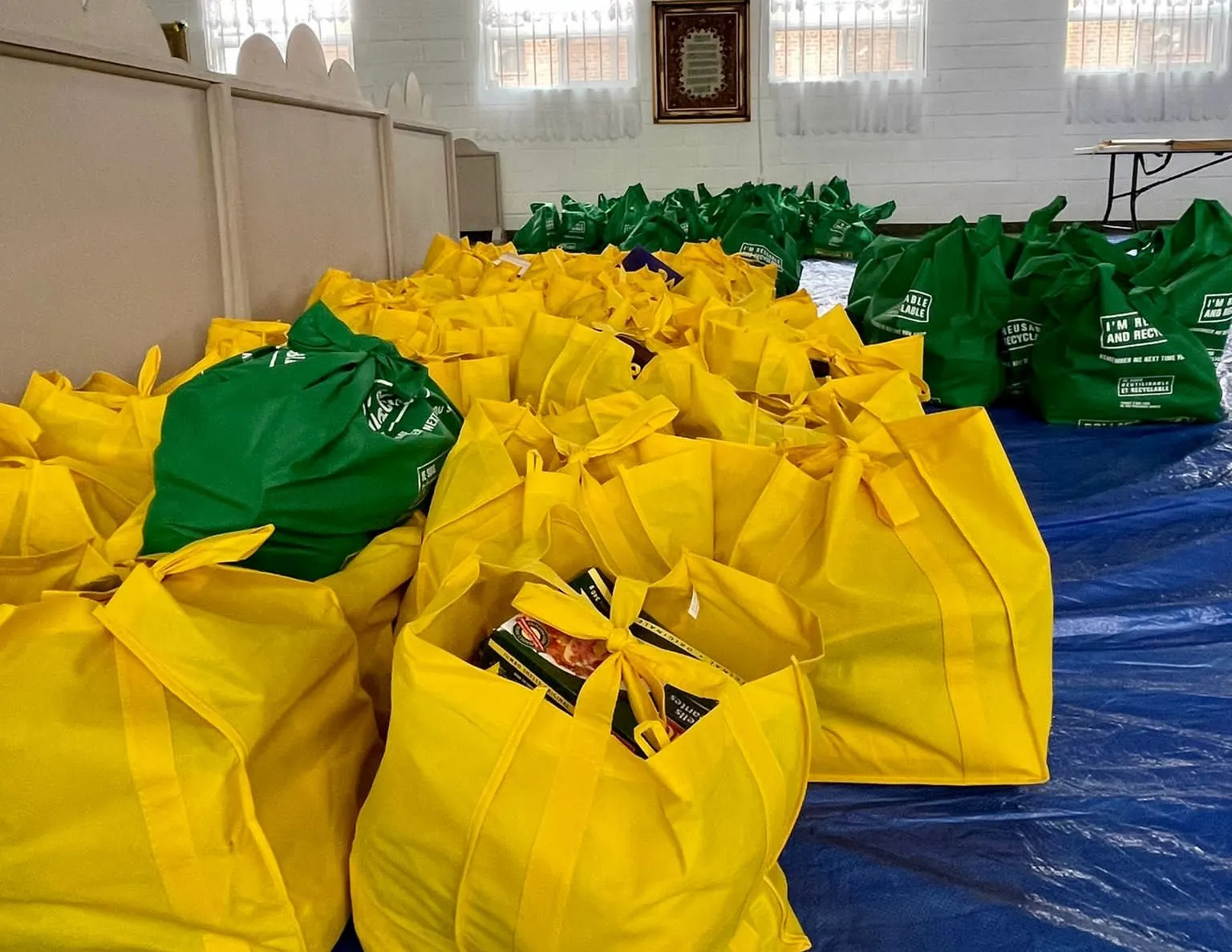 Yellow and green One Love hamper bags packed and ready for families